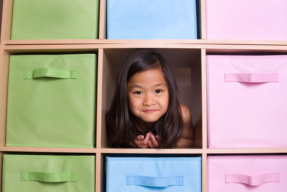 Little girl in bookcase