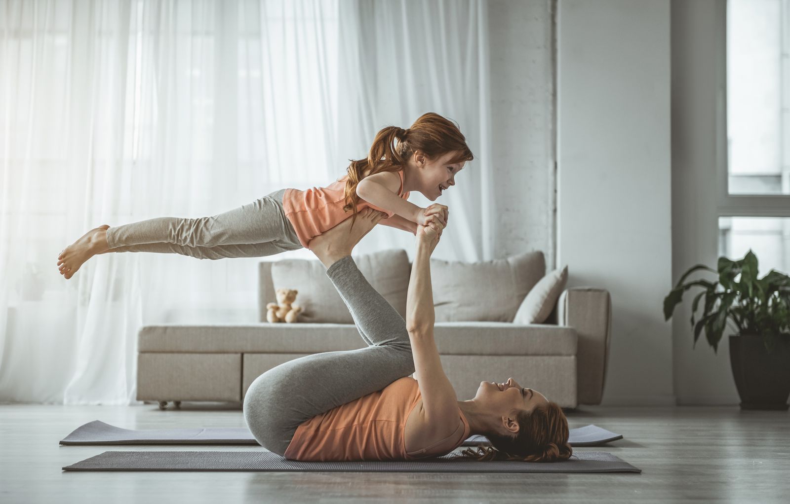 Mother and daughter doing yoga exercise