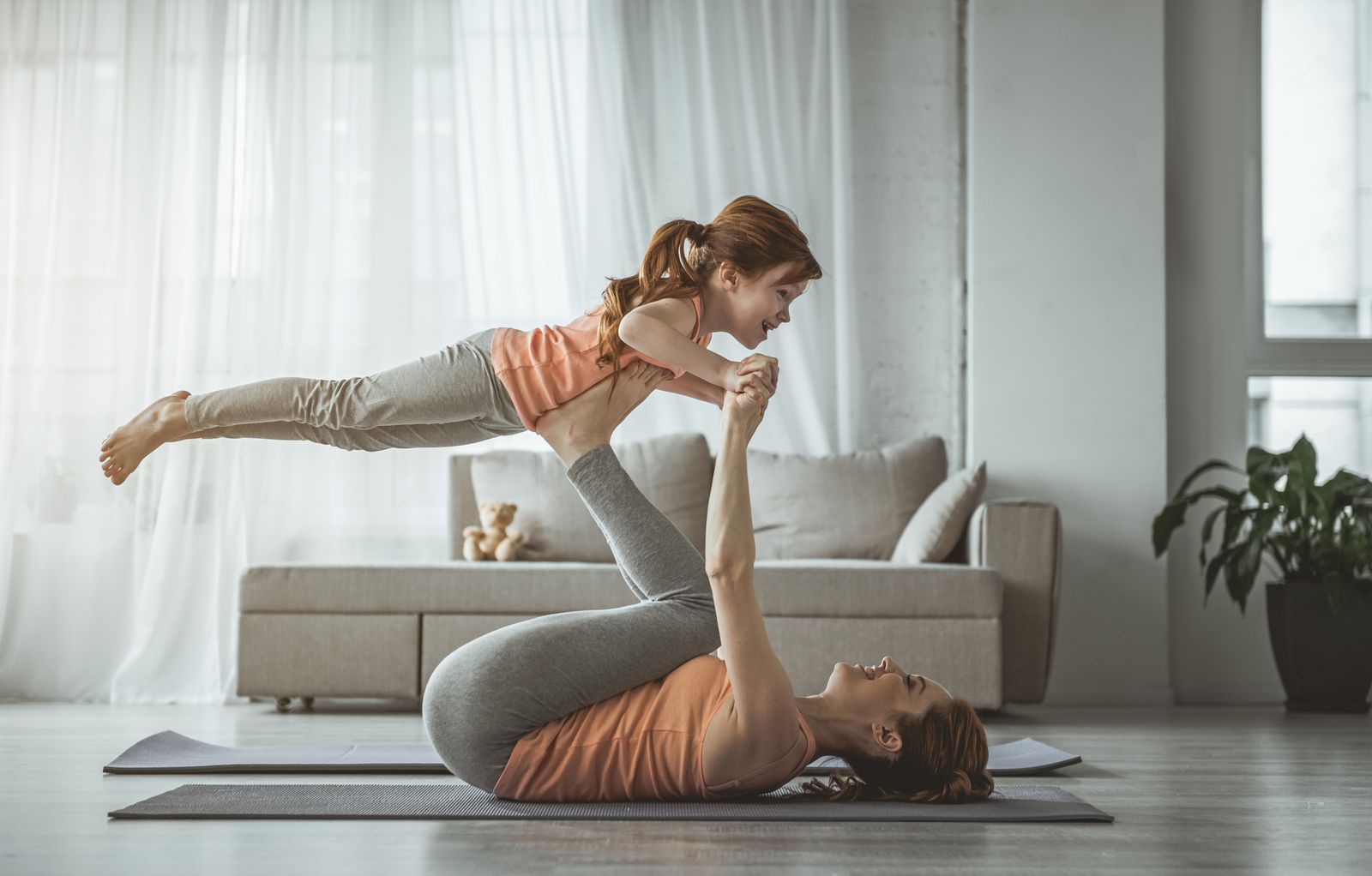 Mother and daughter doing yoga exercise