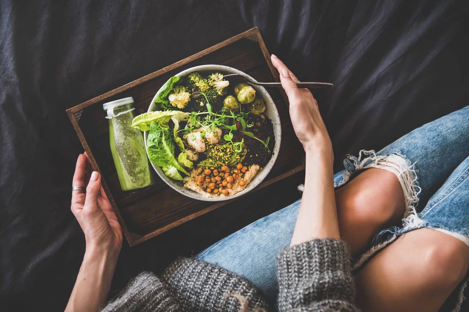 Woman with healthy bowl of green foods