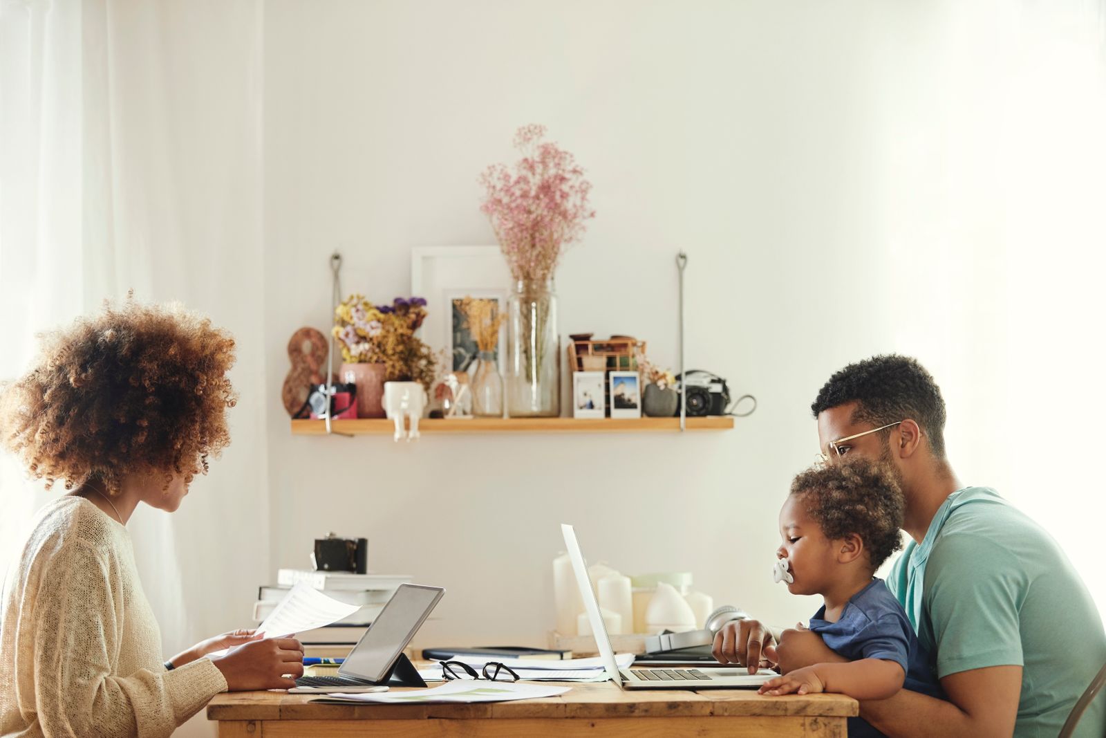 Couple working from home with their child