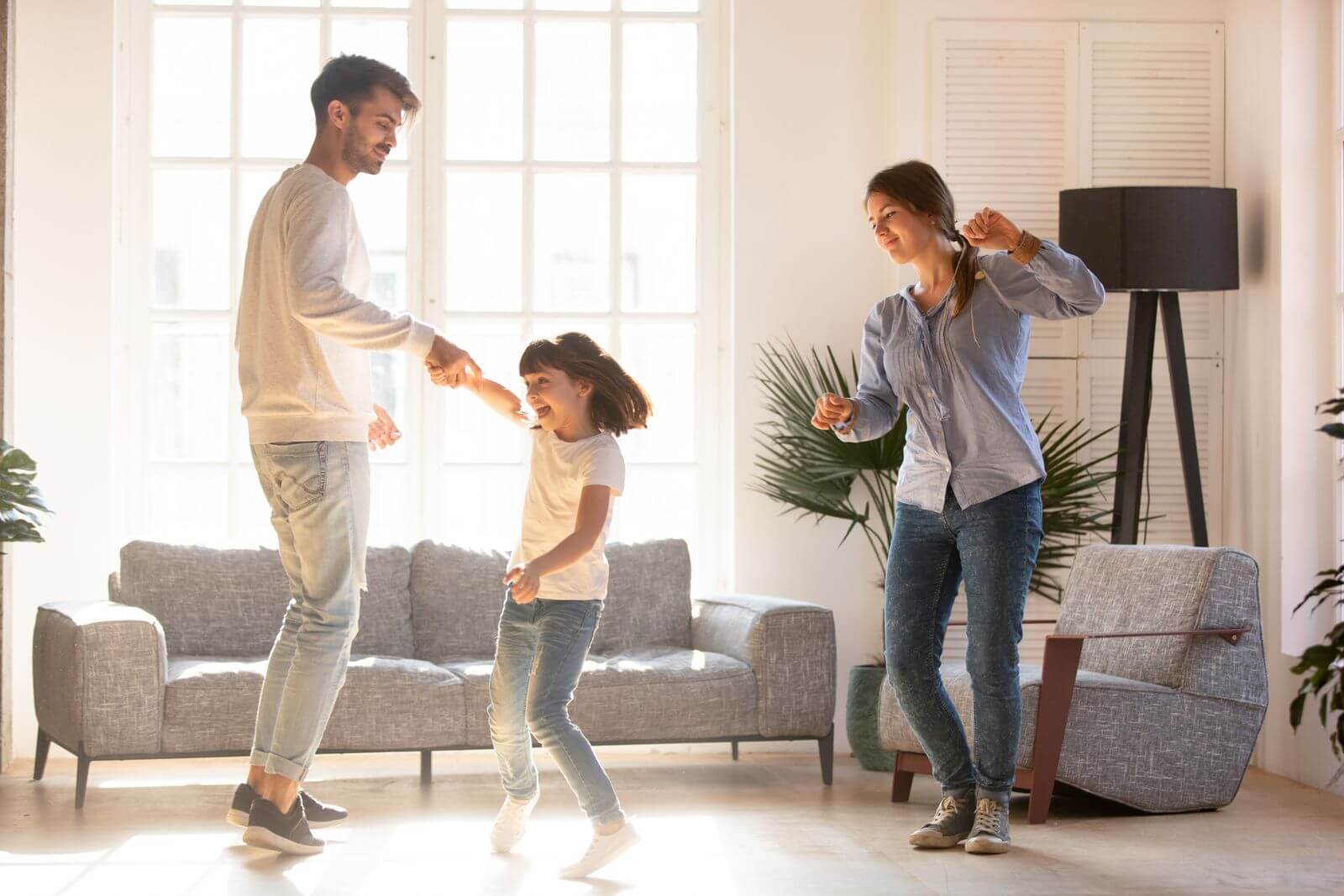 Famille qui dance dans le salon