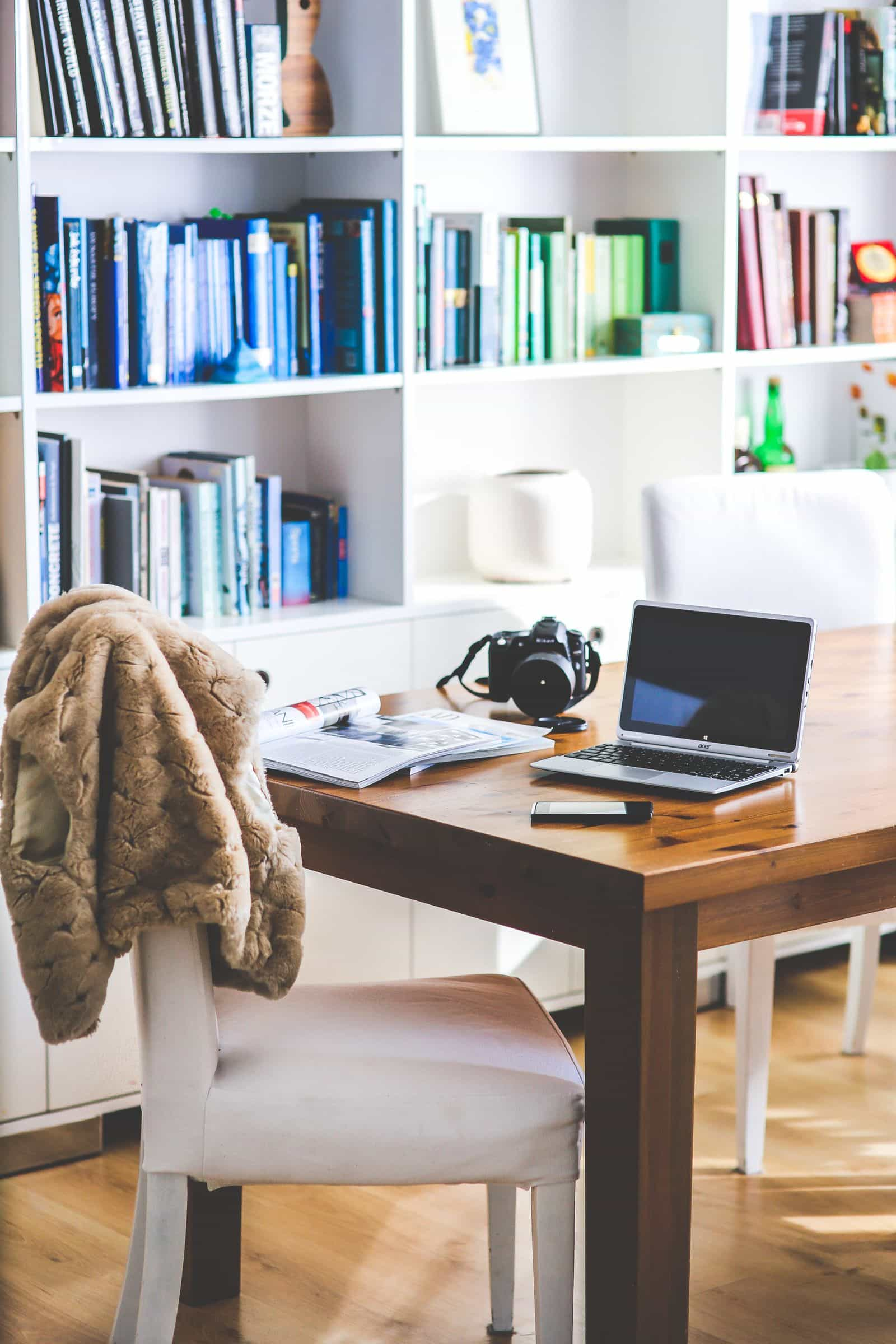 Home office with rainbow bookshelves