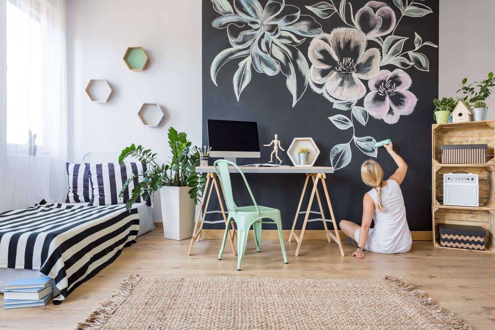 Woman decorating home office chalkboard wall