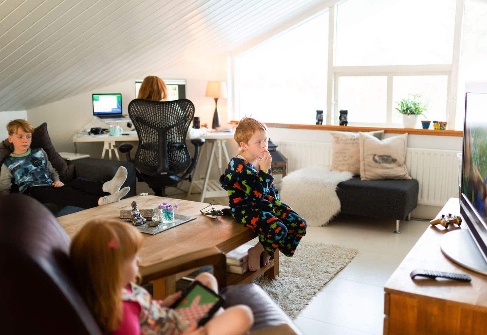 Mom working at home with children around