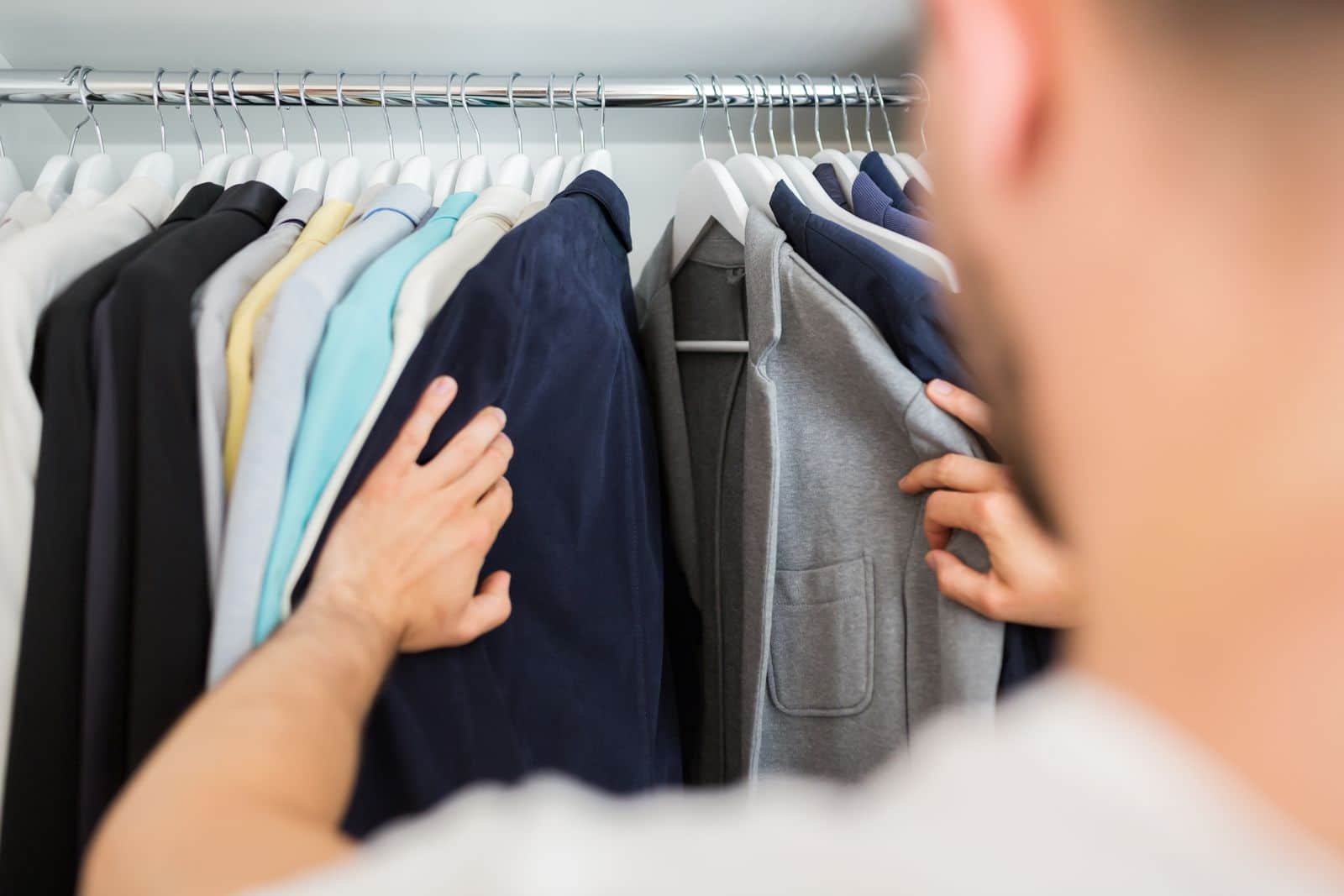 Man looking through his clothes