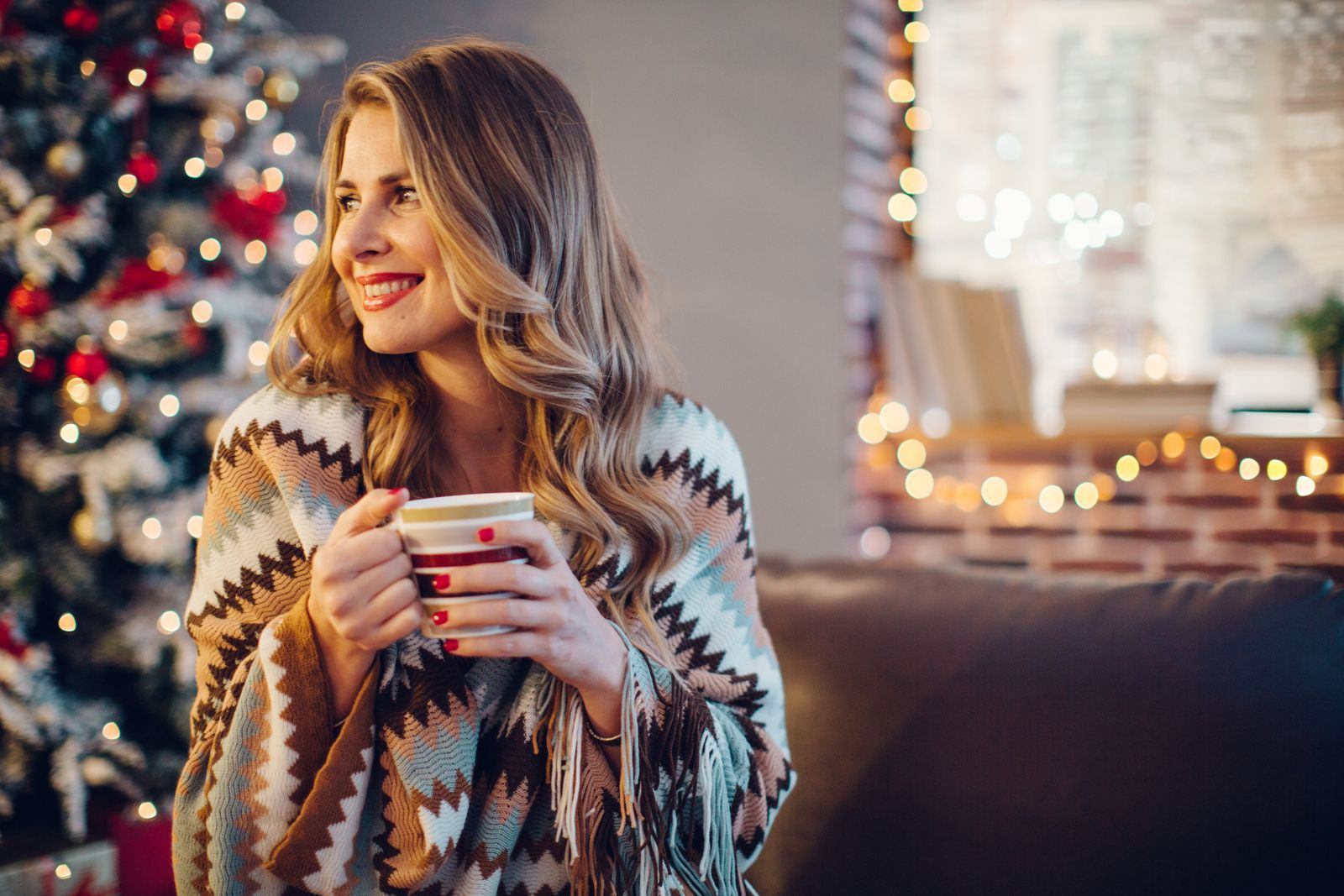Woman enjoying a cozy Christmas atmosphere