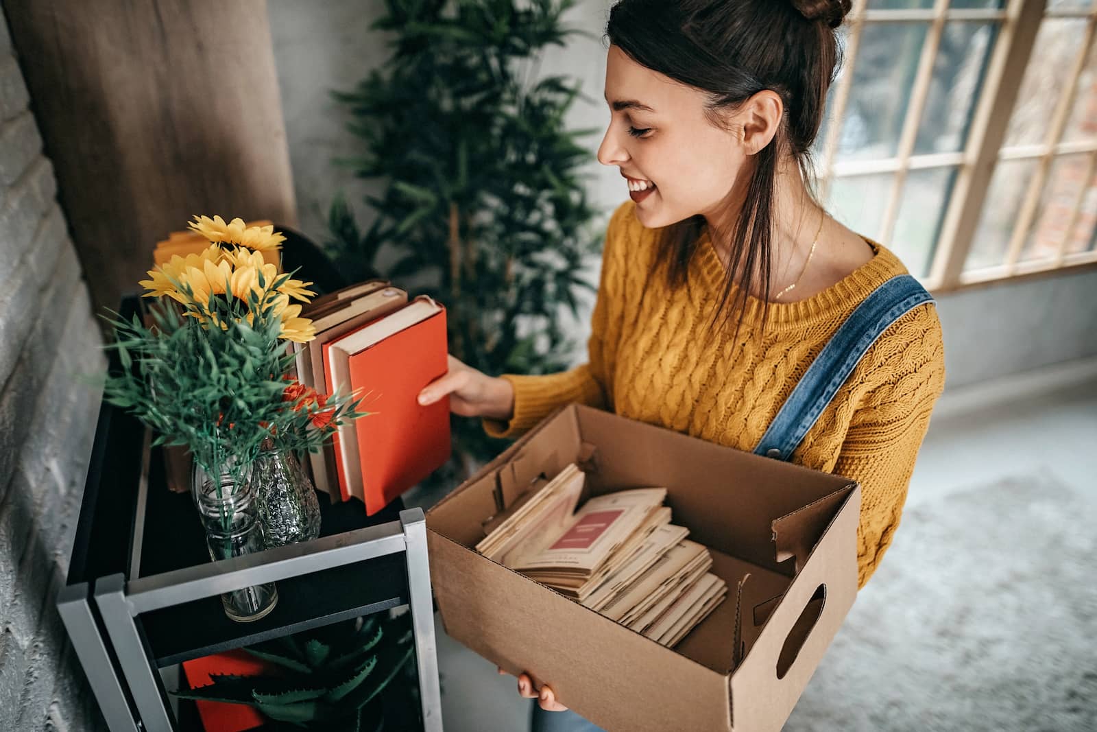 woman organizing books in a bookcase