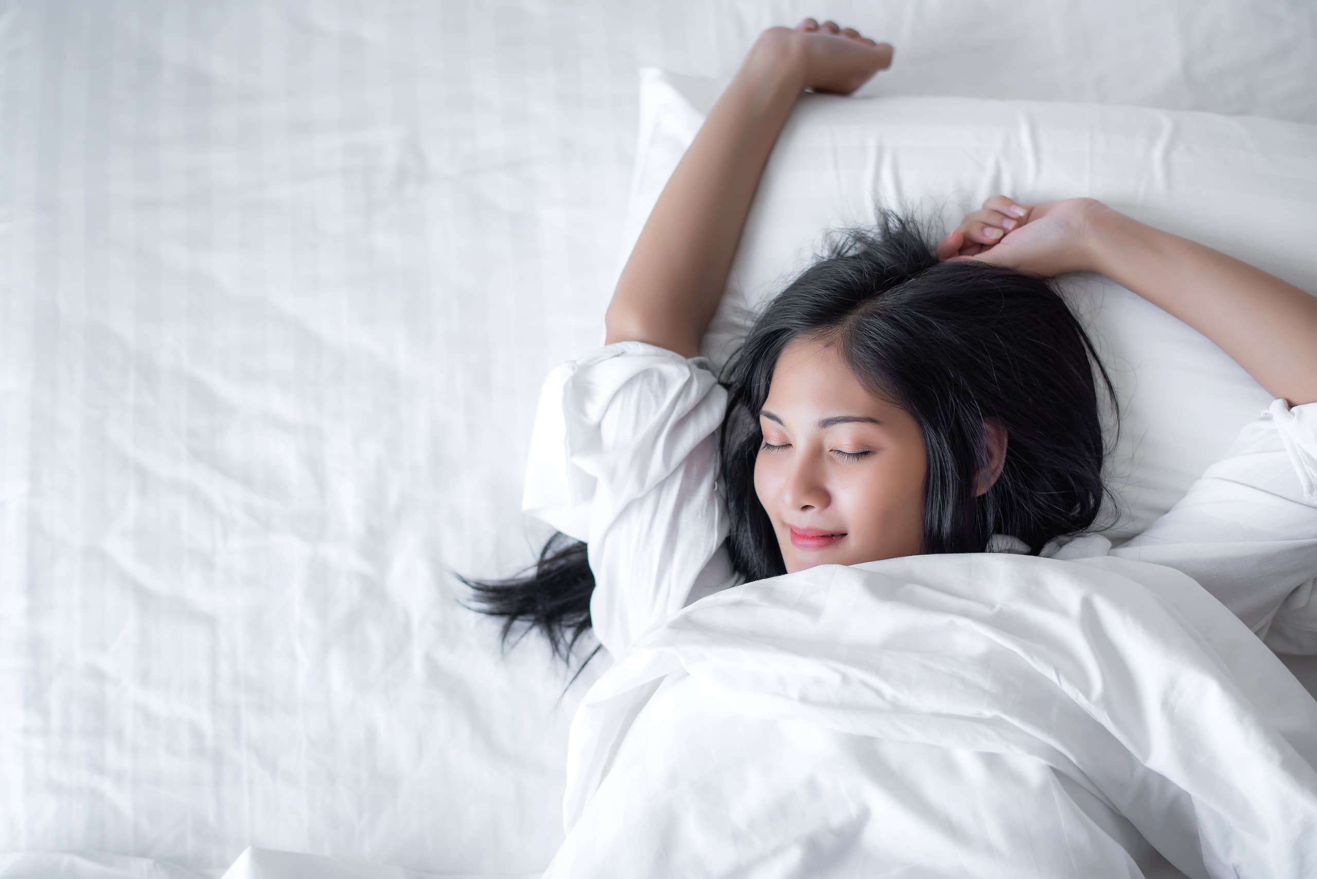 Woman sleeping comfortably in her bed