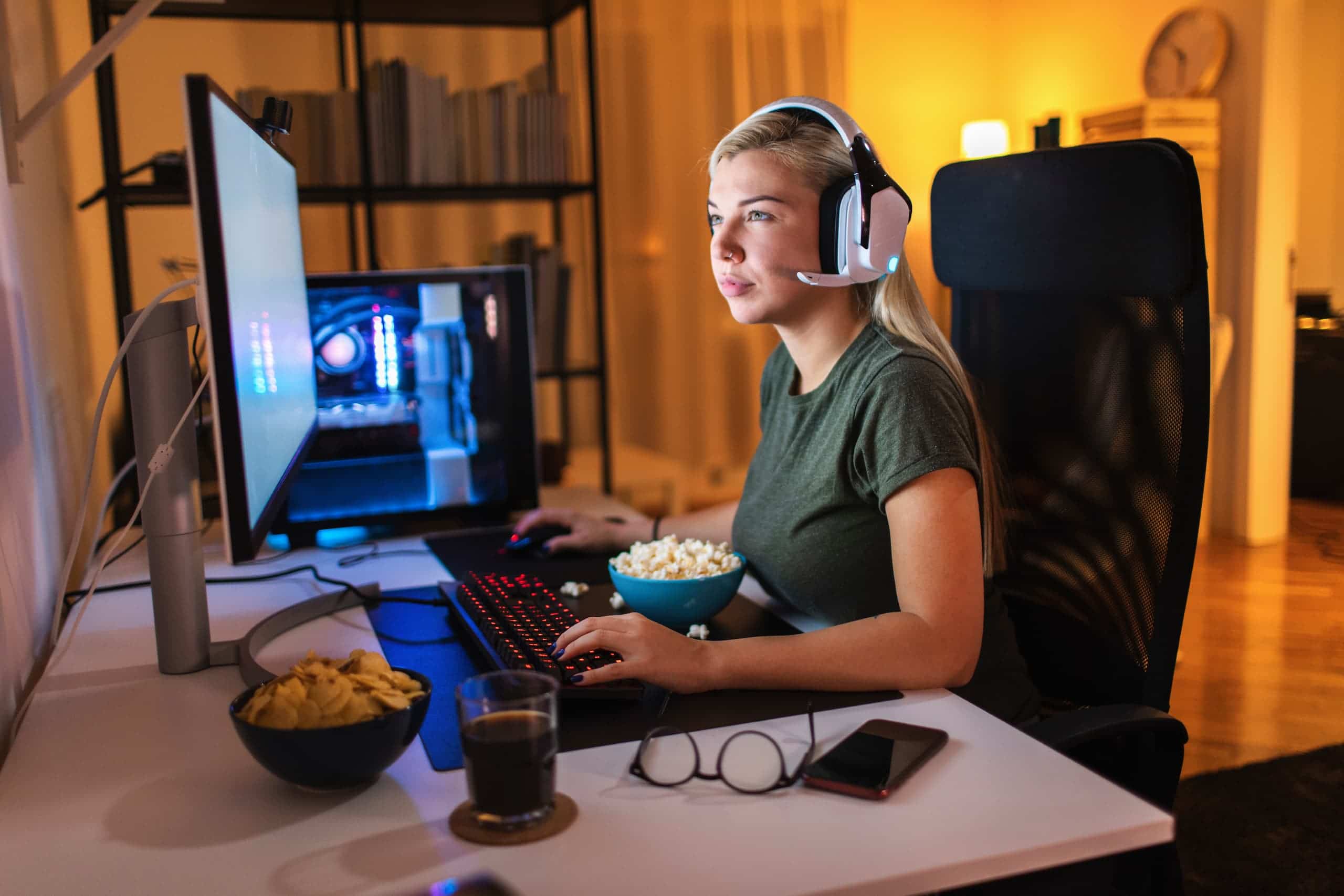 Young woman playing at her gaming desk