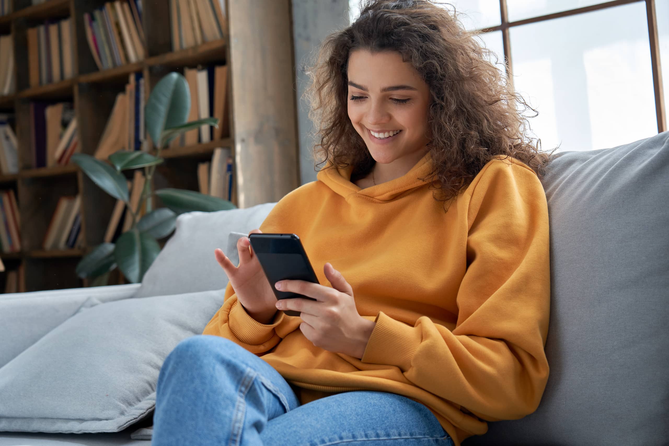 Young woman online shopping for furniture at home