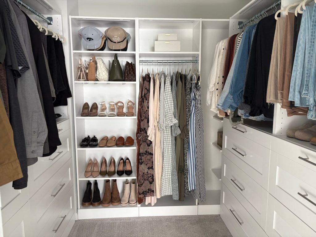 Full view of walk-in closet system with shelves, drawers, and hanging space for clothes and shoes